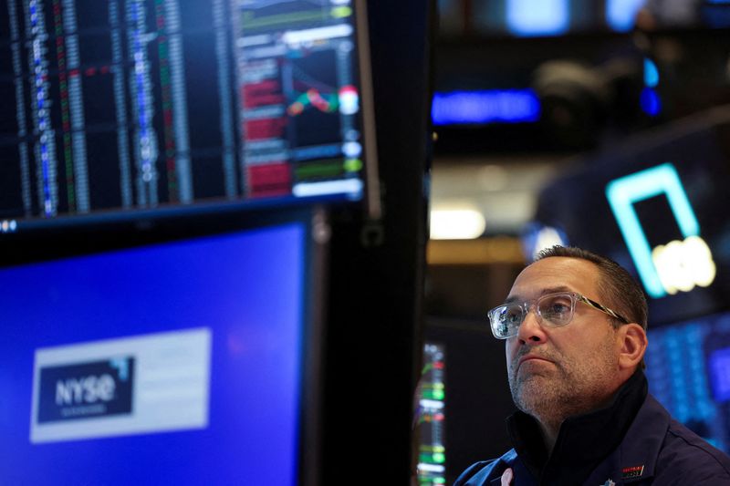 FILE PHOTO: A trader works on the floor at the New York Stock Exchange (NYSE) in New York City, U.S., May 19, 2025. REUTERS/Jeenah Moon/File Photo