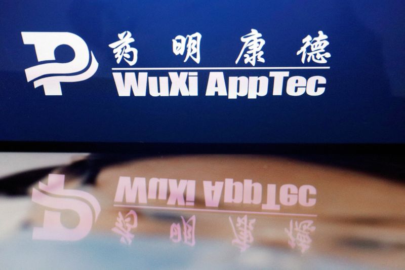 FILE PHOTO: The logo of Chinese drug research and development group WuXi AppTec is displayed alongside its company website, in this illustration picture taken February 5, 2024. REUTERS/Florence Lo/Illustration/File Photo