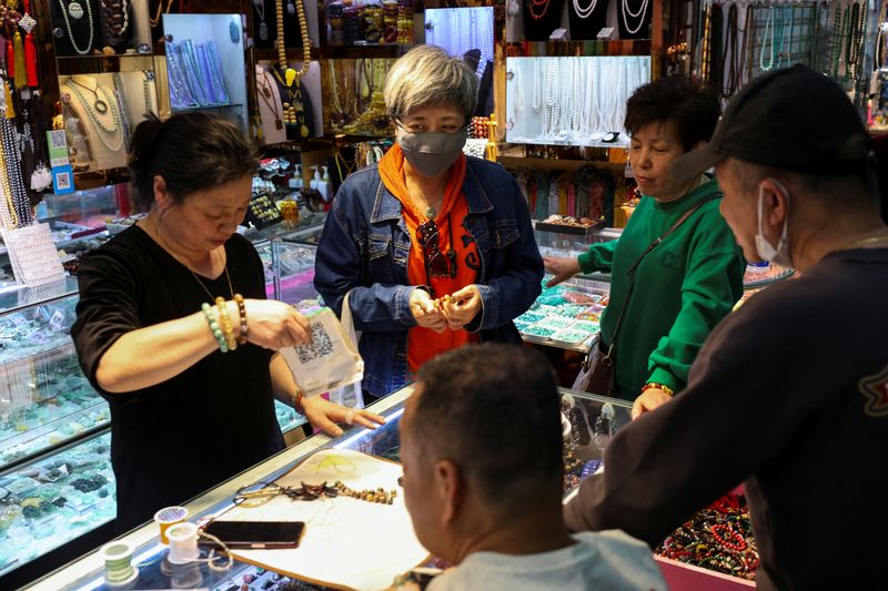 FILE PHOTO: People shop at an accessory store in Fuyoumen Commercial Building in Shanghai, China April 16, 2025. REUTERS/Go Nakamura/File Photo