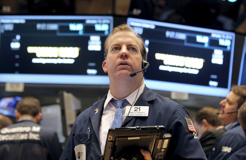 FILE PHOTO: Traders work on the main trading floor of the New York Stock Exchange shortly after the opening bell of the trading session in New York, January 15, 2016. REUTERS/Brendan McDermid/ File Photo