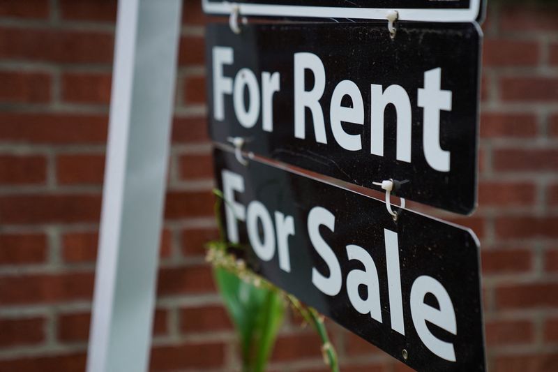 FILE PHOTO: A "For Rent, For Sale" sign is seen outside of a home in Washington, U.S., July 7, 2022. REUTERS/Sarah Silbiger/ File Photo