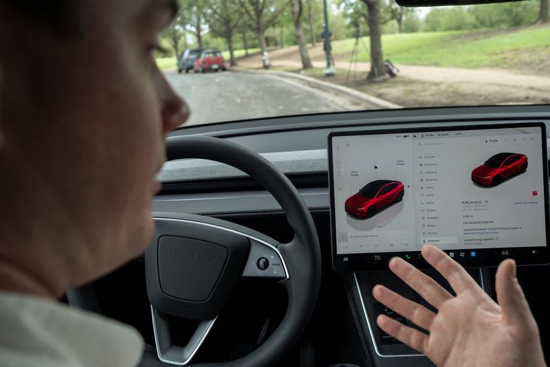 Arthur Maltin, a test driver with The Dawn Project, performs a safety test on a self-driving feature in a Tesla Model Y during a protest against Tesla robotaxis, ahead of the Tesla robotaxis' official services in Austin, Texas, U.S., June 12, 2025.    REUTERS/Joel Angel Juarez