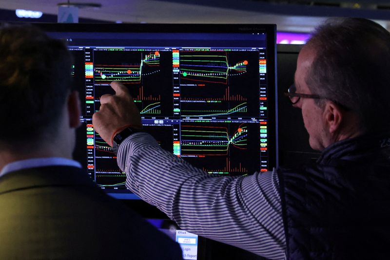 FILE PHOTO: Traders work on the floor at the New York Stock Exchange (NYSE) in New York City, U.S., June 18, 2025. REUTERS/Brendan McDermid/File Photo