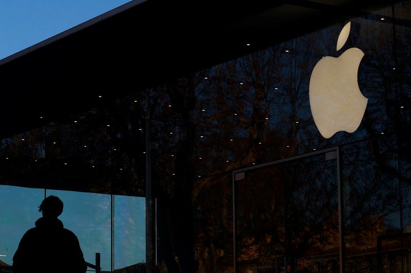 FILE PHOTO: A man walks past an Apple logo outside an Apple store in Aix-en Provence, France, January 15, 2025. REUTERS/Manon Cruz/File photo