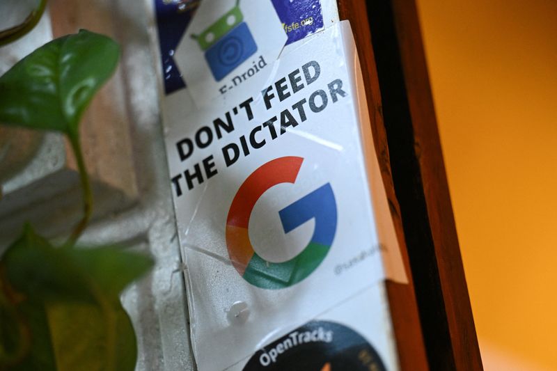 A sticker with a "Don't feed the dictator" message is pictured at the Topio organization's market stall, which supports the transition to alternative operating systems for smartphones, tablets, and laptops, independent of major tech companies like Google or Apple, in Berlin, Germany April 23, 2025. REUTERS/Annegret Hilse
