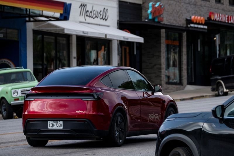A Tesla robotaxi with no backseat passengers drives on the street along South Congress Avenue in Austin, Texas, U.S., June 22, 2025.    REUTERS/Joel Angel Juarez