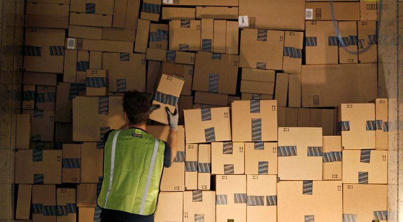 FILE PHOTO: A worker stacks a shipping trailer with boxed items for delivery at Amazon's distribution center in Phoenix, Arizona November 22, 2013.  REUTERS/Ralph D. Freso/File Photo