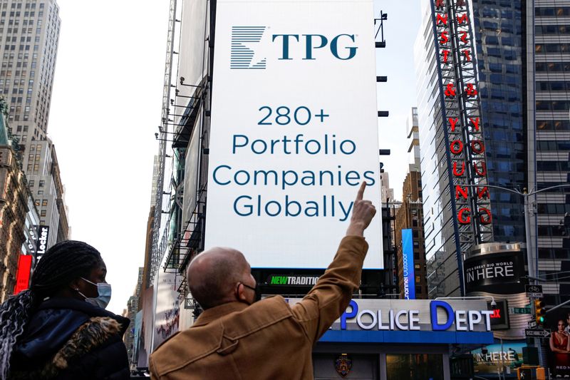 FILE PHOTO: A screen announces the listing of Private-equity firm TPG, during the IPO at the Nasdaq Market site in Times Square in New York City, U.S., January 13, 2022. REUTERS/Brendan McDermid/File Photo