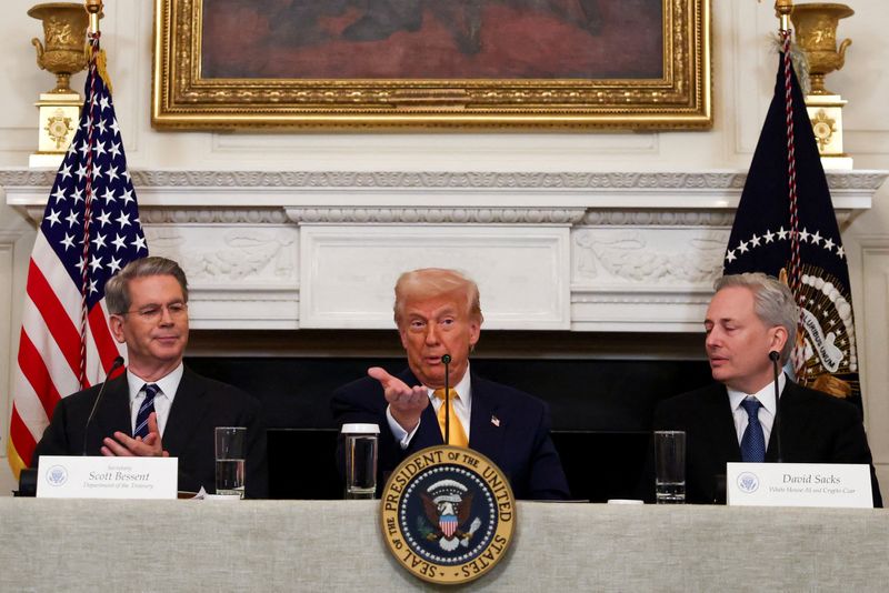 FILE PHOTO: U.S. President Donald Trump speaks next to Crypto czar David Sacks and U.S. Treasury Secretary Scott Bessent at the White House Crypto Summit at the White House in Washington, D.C., U.S.,  March 7, 2025. REUTERS/Evelyn Hockstein/File Photo