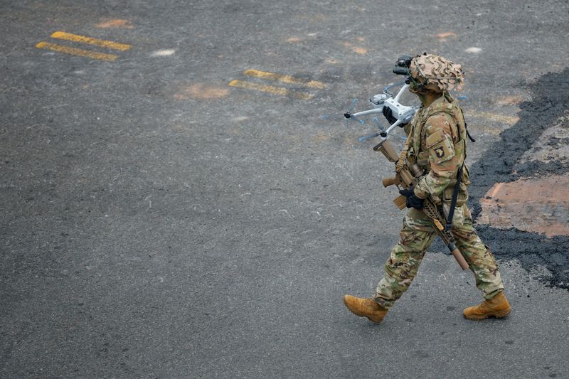 FILE PHOTO: A member of the military holds a drone during the U.S. Army's 250th Birthday parade in Washington, D.C., U.S., June 14, 2025. REUTERS/Brian Snyder/File Photo