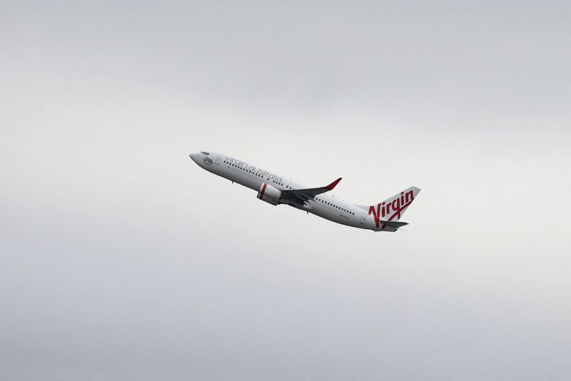 FILE PHOTO: A Virgin Australia Airlines Boeing 737-800 plane takes off from Sydney Airport in Sydney, Australia, October 28, 2020.  REUTERS/Loren Elliott/File Photo