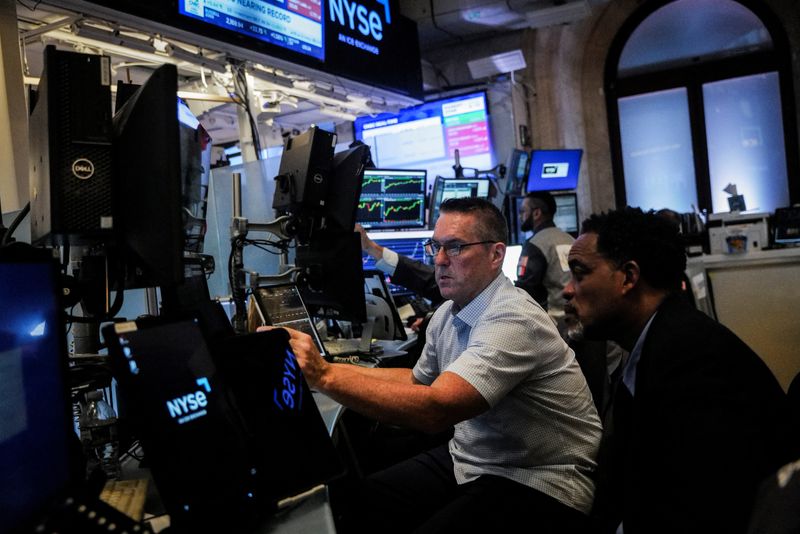 Traders work on the floor at the New York Stock Exchange (NYSE) in New York City, U.S., June 26, 2025. REUTERS/Jeenah Moon