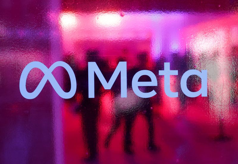 FILE PHOTO: People walk behind a logo of Meta Platforms company, during a conference in Mumbai, India, September 20, 2023. REUTERS/Francis Mascarenhas/File Photo