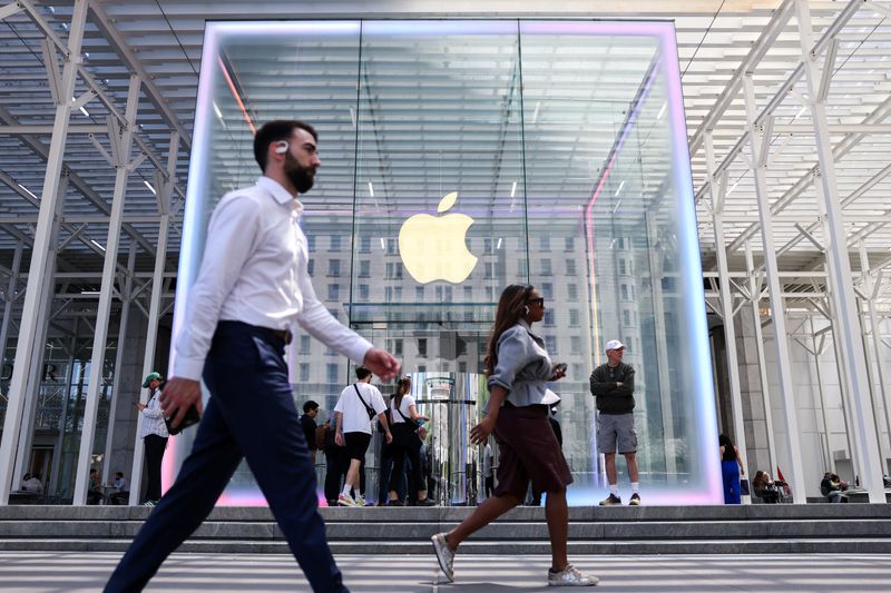 FILE PHOTO: People walk by the Apple store on Fifth Avenue in New York City, U.S., May 1, 2025. REUTERS/Kylie Cooper/ File Photo