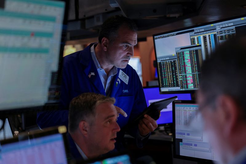 Traders work on the floor at the New York Stock Exchange (NYSE) in New York City, U.S., June 27, 2025. REUTERS/Jeenah Moon