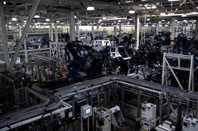 FILE PHOTO: Machinery assembles second-generation R1 vehicles at electric auto maker Rivian's manufacturing facility in Normal, Illinois, U.S. June 21, 2024.  REUTERS/Joel Angel Juarez/File Photo