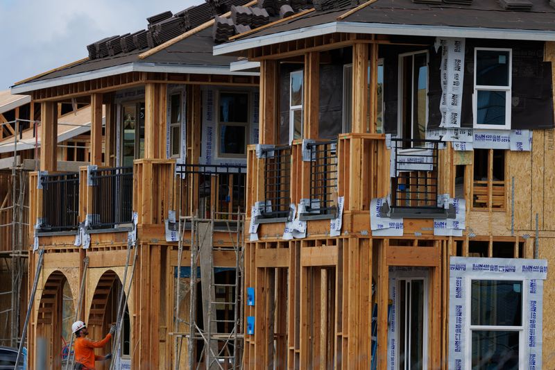 FILE PHOTO: A construction worker helps build residential homes in Irvine, California, U.S., March 28, 2025.  REUTERS/Mike Blake/File Photo