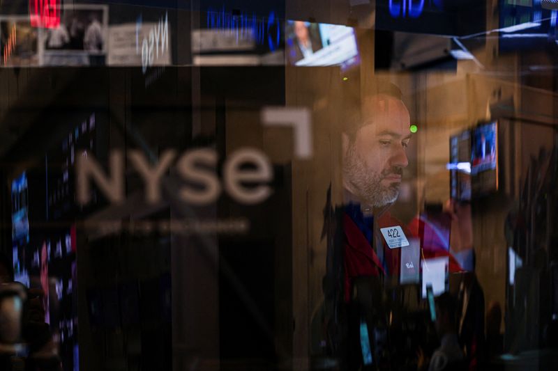 FILE PHOTO: A trader works on the floor at the New York Stock Exchange (NYSE) in New York City, U.S., June 27, 2025. REUTERS/Jeenah Moon/ File Photo