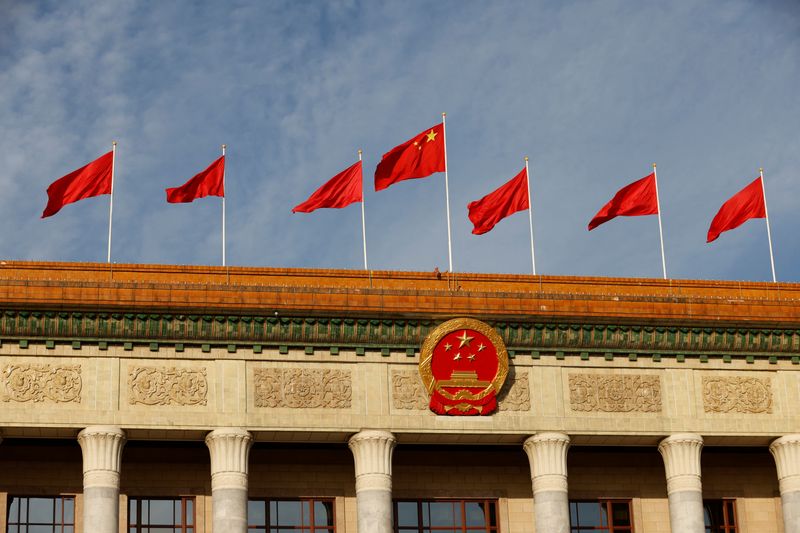 FILE PHOTO: A Chinese flag flutters on top of the Great Hall of the People in Beijing, China October 18, 2023. REUTERS/Edgar Su/File photo