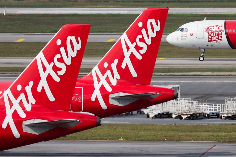 FILE PHOTO: Planes from AirAsia, a subsidiary airline of Capital A, are seen on the tarmac of Kuala Lumpur International Airport Terminal 2 (KLIA2) in Sepang, Malaysia, February 26, 2024. REUTERS/Hasnoor Hussain/File Photo