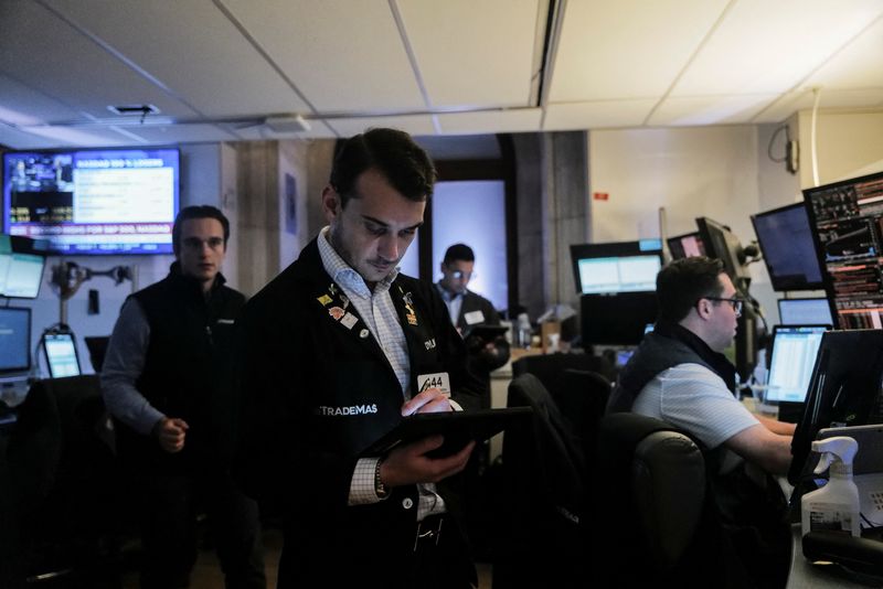 FILE PHOTO: Traders work on the floor at the New York Stock Exchange (NYSE) in New York City, U.S., June 27, 2025. REUTERS/Jeenah Moon/File Photo