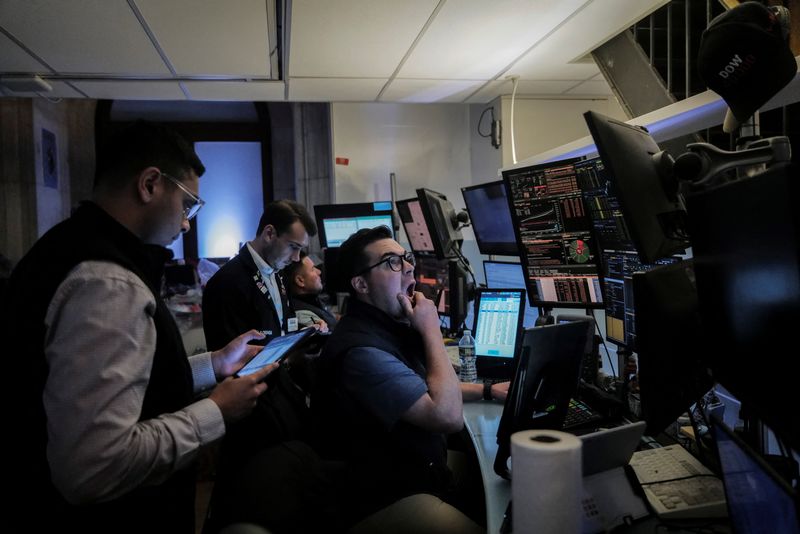 FILE PHOTO: Traders work on the floor at the New York Stock Exchange (NYSE) in New York City, U.S., June 26, 2025. REUTERS/Jeenah Moon/File Photo
