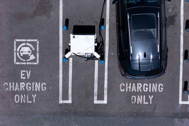 FILE PHOTO: An electric vehicle charging location is shown from the view of a drone in Carlsbad, California, U.S., May 14, 2025. REUTERS/Mike Blake/ File Photo