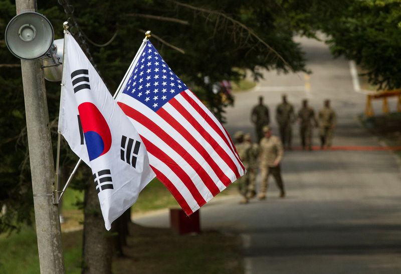 FILE PHOTO: The South Korean and American flags fly next to each other at Yongin, South Korea, August 23, 2016. Courtesy Ken Scar/U.S. Army/Handout via REUTERS/ File Photo