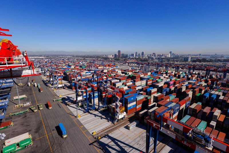 Automated electric trucks transport shipping container at the Long Beach Container Terminal in Long Beach, California, U.S., February 9, 2023.   REUTERS/Mike Blake/File photo