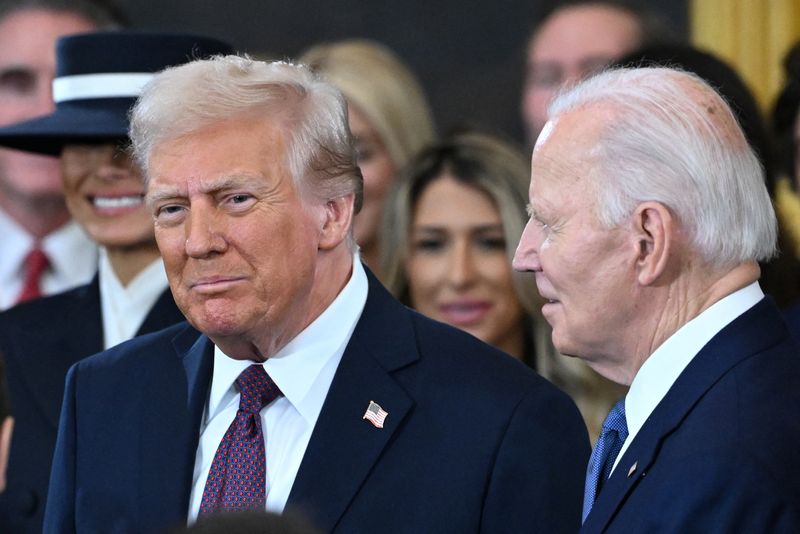 FILE PHOTO: US President Joe Biden looks on as US President-elect Donald Trump arrives during the inauguration ceremony before  Trump is sworn in as the 47th US President in the US Capitol Rotunda in Washington, DC, on January 20, 2025.     SAUL LOEB/Pool via REUTERS/File Photo