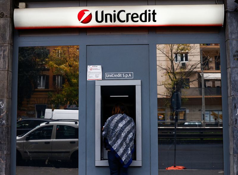 FILE PHOTO: A person uses an ATM at a UniCredit bank branch in Rome, Italy, November 25, 2024. REUTERS/Yara Nardi/File Photo