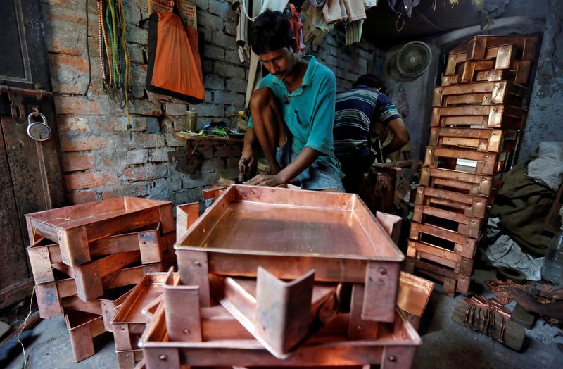 FILE PHOTO: A worker makes copper trays inside a workshop in Kolkata, India, October 26, 2017. Picture taken October 26, 2017. REUTERS/Rupak De Chowdhuri/File Photo