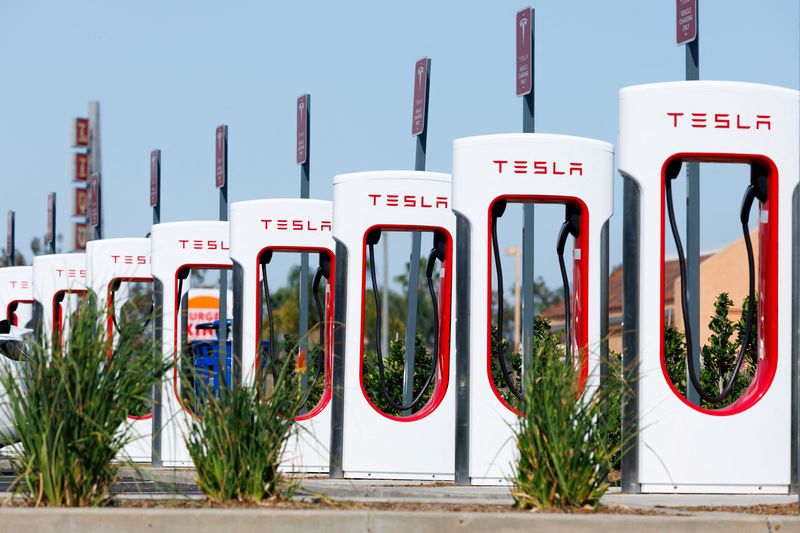 FILE PHOTO: A view shows Tesla superchargers at the supercharging station in Escondido, California, U.S., July 3, 2025. REUTERS/Mike Blake/File Photo