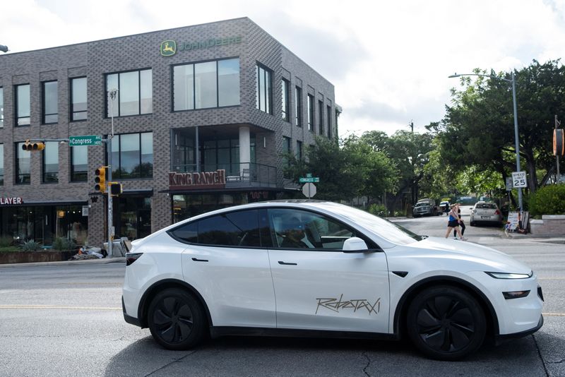 A Tesla robotaxi drives on the street along South Congress Avenue in Austin, Texas, U.S., June 22, 2025. REUTERS/Joel Angel Juarez/File Photo