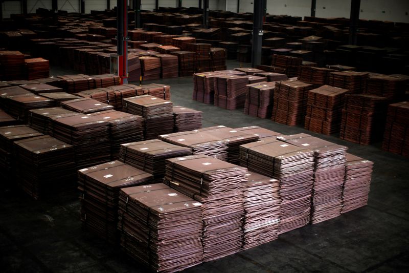 FILE PHOTO: Copper cathodes are seen inside a warehouse near Yangshan Deep Water Port, south of Shanghai March 23, 2012. REUTERS/Carlos Barria/File Photo
