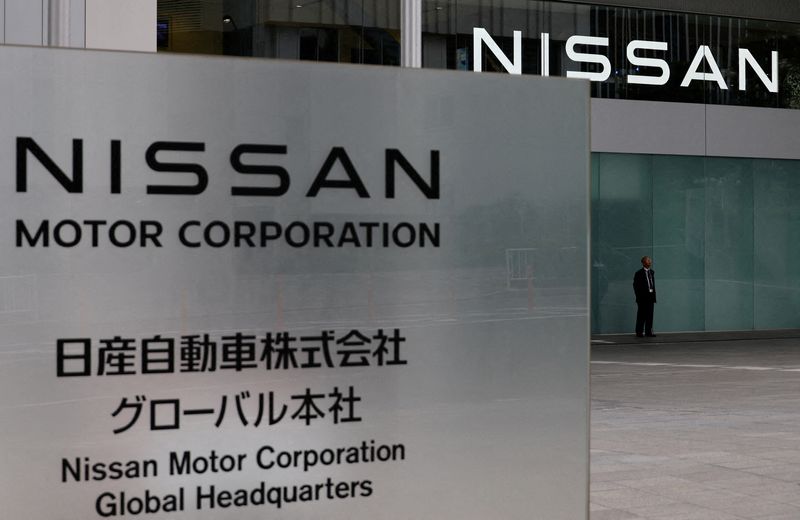FILE PHOTO: A man stands in front of the global headquarters of Nissan Motor while its annual shareholder meeting is being held in Yokohama, Japan, June 24, 2025. REUTERS/Kim Kyung-Hoon/File Photo