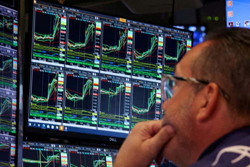 FILE PHOTO: Traders work on the floor at the New York Stock Exchange (NYSE) in New York City, U.S., May 12, 2025.  REUTERS/Brendan McDermid/File Photo