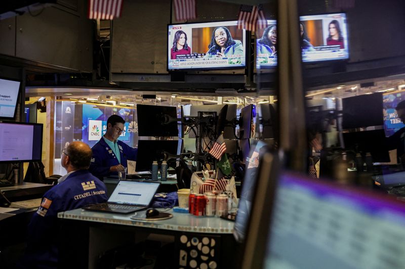 FILE PHOTO: Traders work on the floor at the New York Stock Exchange (NYSE) in New York City, U.S., July 10, 2025. REUTERS/Jeenah Moon/File Photo