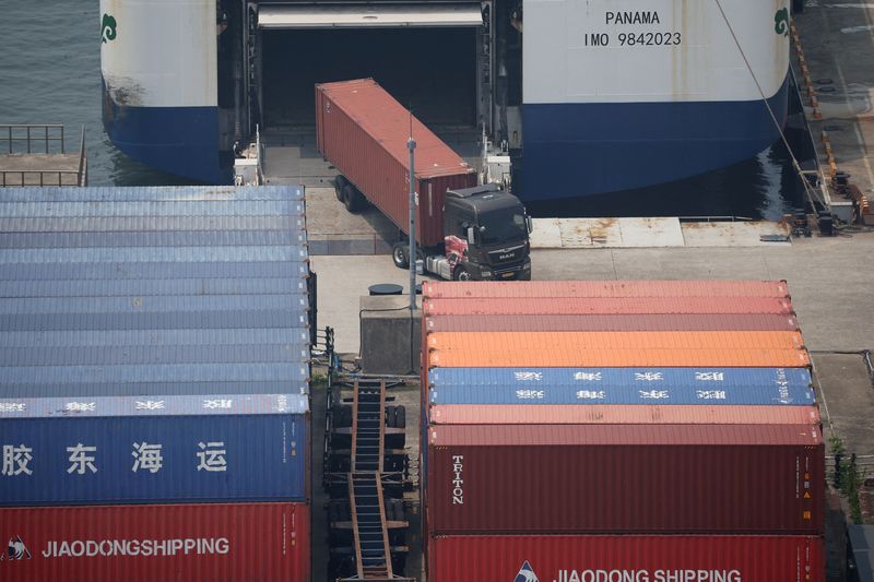 FILE PHOTO: A truck unloads a shipping container at Pyeongtaek port in Pyeongtaek, South Korea, July 8, 2025. REUTERS/Kim Hong-Ji/File Photo