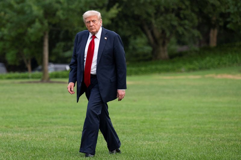 FILE PHOTO: U.S. President Donald Trump walks on the South Lawn as he arrives at the White House in Washington, D.C., U.S., July 13, 2025. REUTERS/Annabelle Gordon/ File Photo