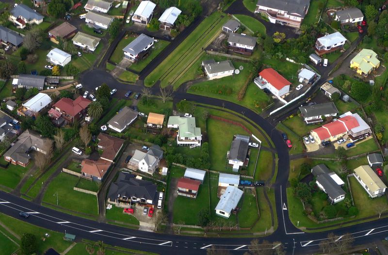 FILE PHOTO: Residential houses can be seen along a road in a suburb of Auckland in New Zealand, June 24, 2017. Picture taken June 24, 2017. REUTERS/David Gray/ File Photo