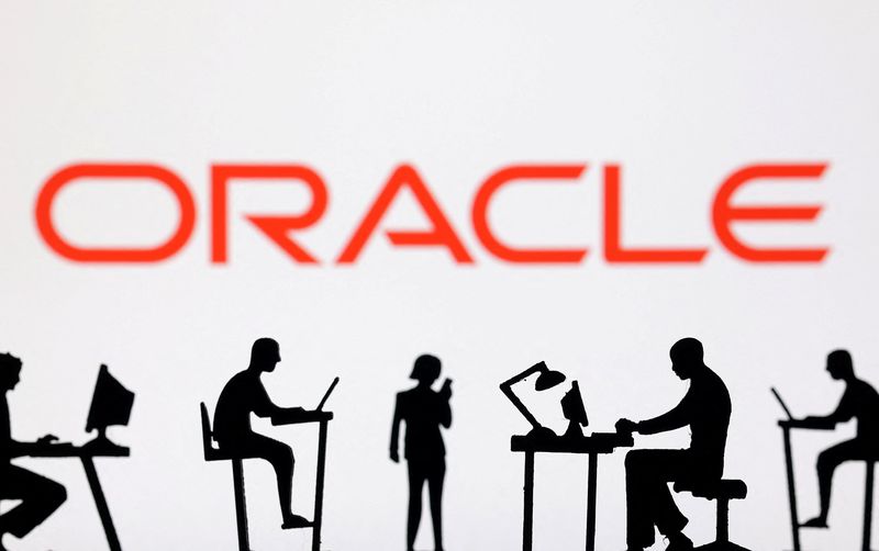 Figurines with computers and smartphones are seen in front of Oracle logo in this illustration taken, February 19, 2024. REUTERS/Dado Ruvic/Illustration