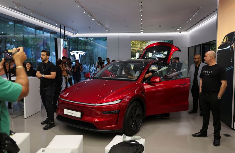 Media personnel take pictures and videos of the TESLA Model Y car at India's first Tesla showroom in Mumbai, India, July 15, 2025. REUTERS/Francis Mascarenhas