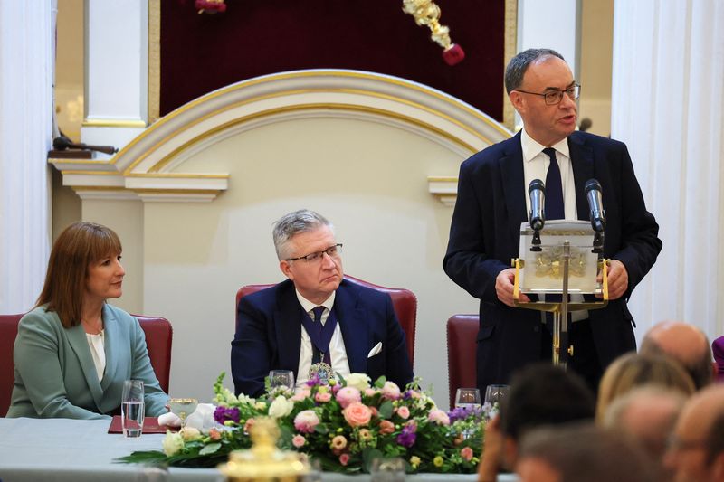 Bank of England Governor Andrew Bailey delivers a speech, while British Chancellor of the Exchequer Rachel Reeves and Lord Mayor of London Alastair King sit, during the annual Mansion House dinner in London, Britain, July 15, 2025. REUTERS/Isabel Infantes