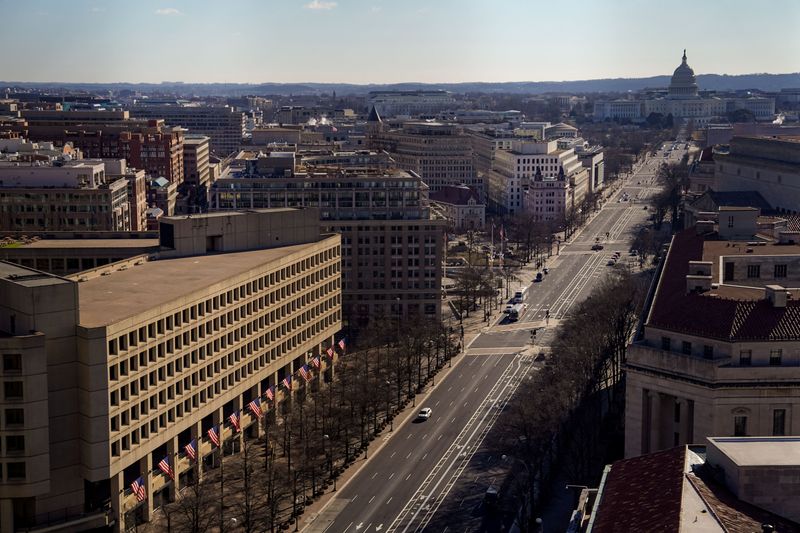 The J. Edgar Hoover Building, the headquarters of the Federal Bureau of Investigation and the dome of the U.S. Capitol are seen from the Old Post Office Tower after U.S. President Donald Trump threw his support behind calls for a federal government takeover of the U.S. capital, in Washington, D.C., U.S., February 21, 2025. REUTERS/Kent Nishimura/File Photo
