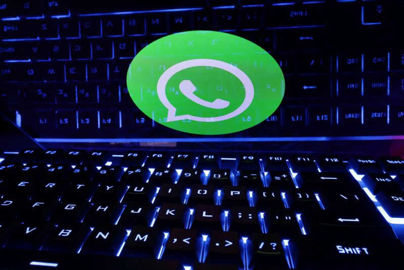 A keyboard is placed in front of a displayed WhatsApp logo in this illustration taken February 21, 2023. REUTERS/Dado Ruvic/Illustration