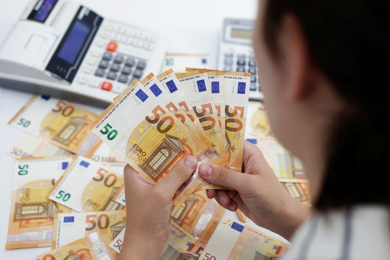 A woman holds Euro banknotes in this illustration taken May 30, 2022. REUTERS/Dado Ruvic/Illustration/File Photo