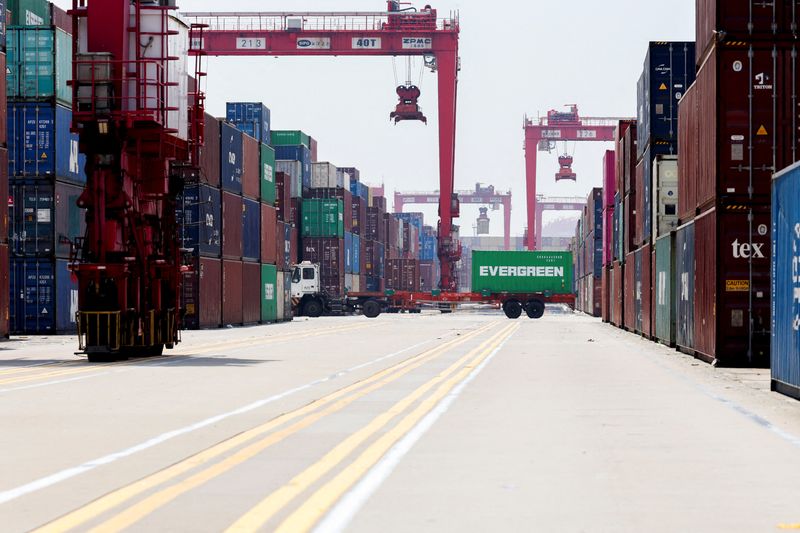 FILE PHOTO: Gantry cranes stand near shipping containers at Yangshan Port outside of Shanghai, China, June 17, 2025. REUTERS/Go Nakamura/File Photo