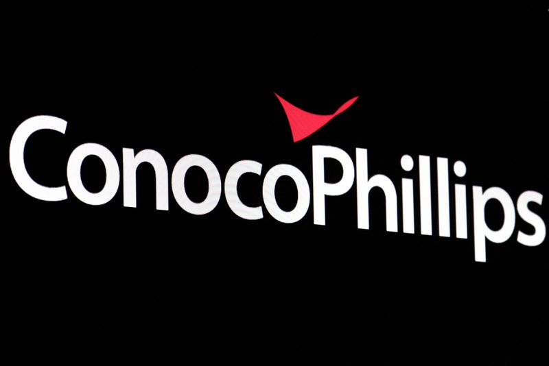 FILE PHOTO: A screen displays the logo for ConocoPhillips on the floor of the New York Stock Exchange (NYSE) in New York City, U.S., April 6, 2022. REUTERS/Brendan McDermid/File Photo