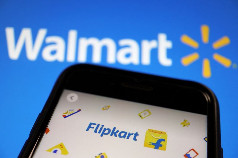 FILE PHOTO: A mobile phone showing an image of Indian online retailer Flipkart is seen in front of a Walmart Inc logo displayed in this illustration picture taken July 14, 2021. REUTERS/Florence Lo/Illustration/File Photo